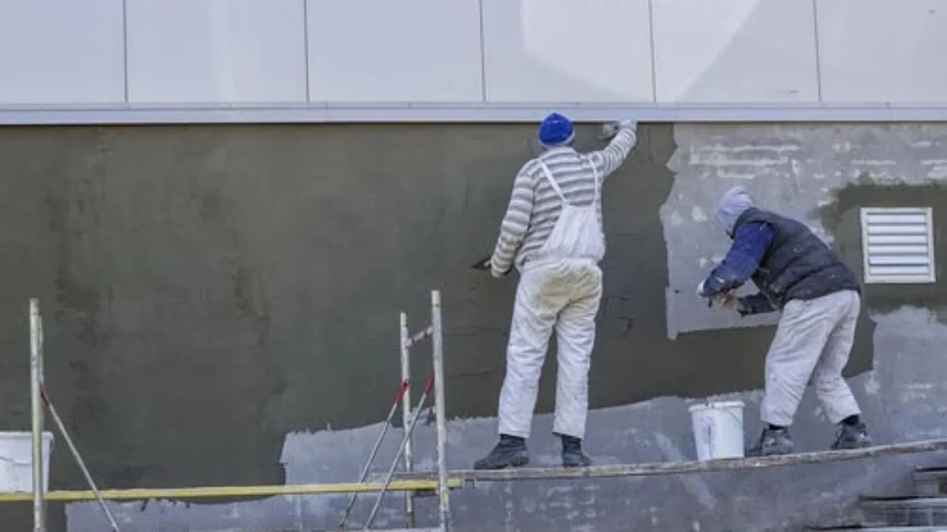 ABC Masonry and Stucco Contractors team applying stucco finish to building exterior in NYC